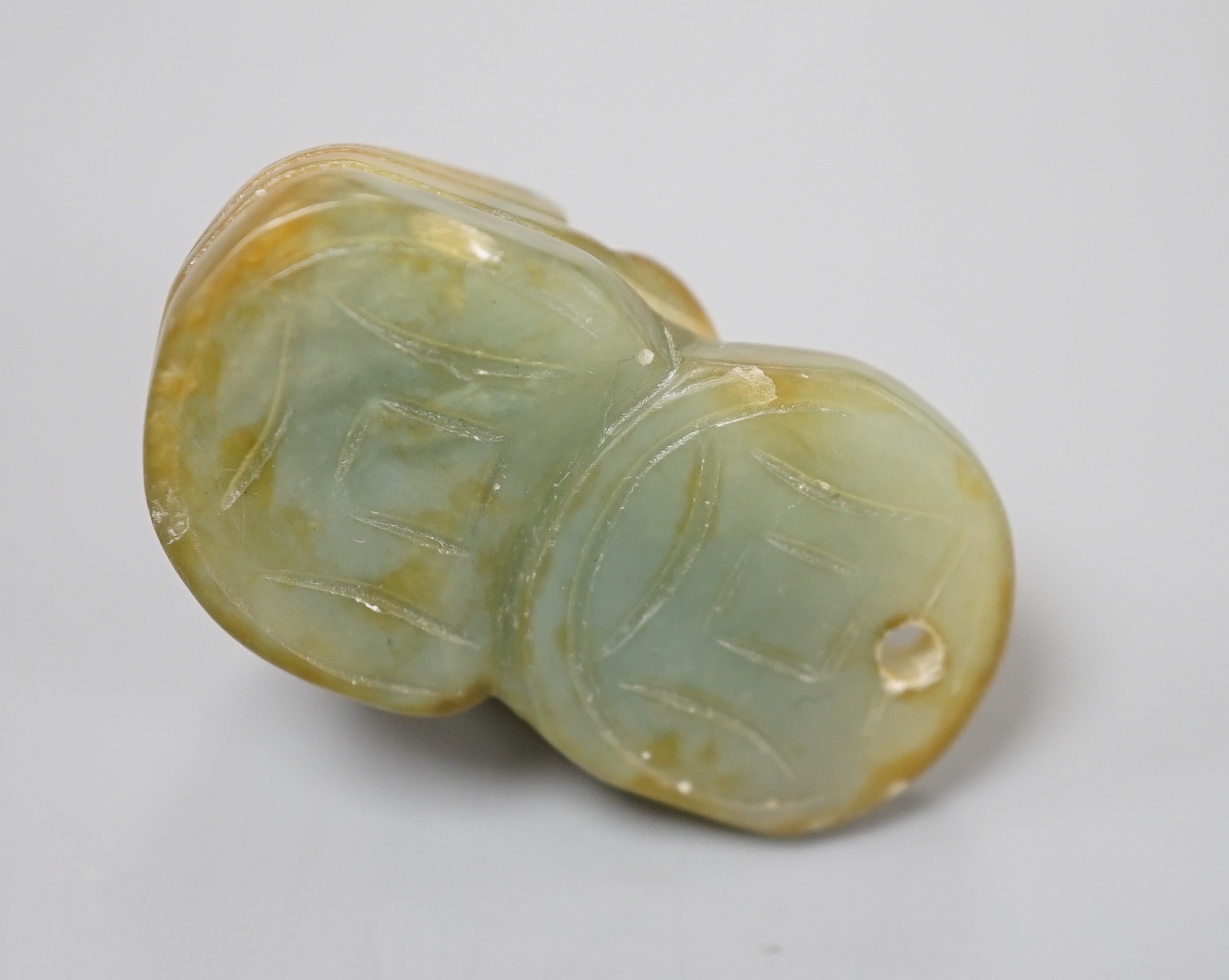 A Chinese jade fish and cash pendant, 3.4cm